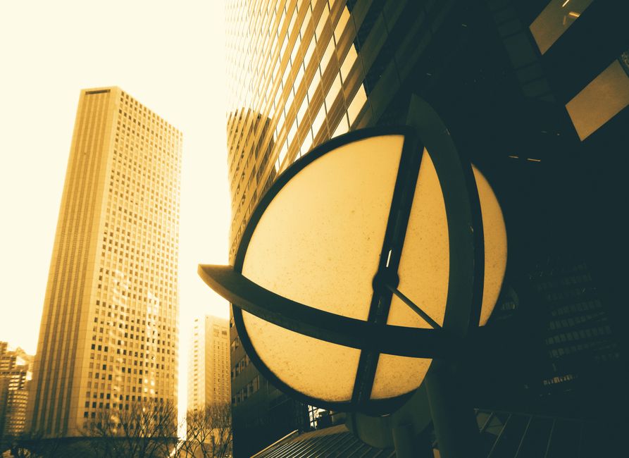 Low angle view of modern skyscrapers with unique sunlit design in an urban setting.